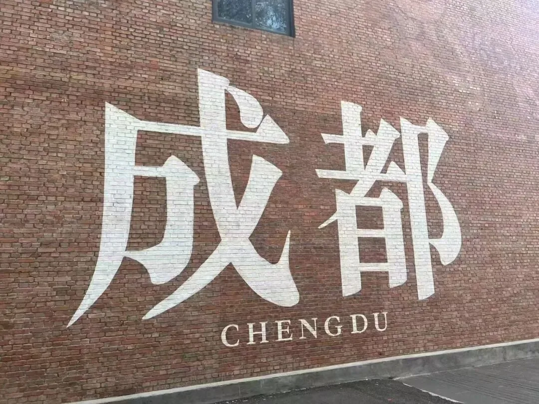 Side-angle view of the Chengdu red wall shot from a cafe terrace balcony