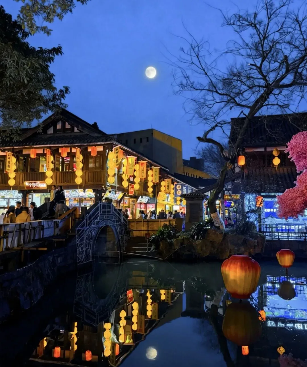 Jinli Ancient Street entrance archway with red lanterns, highlighting hidden alleys to explore