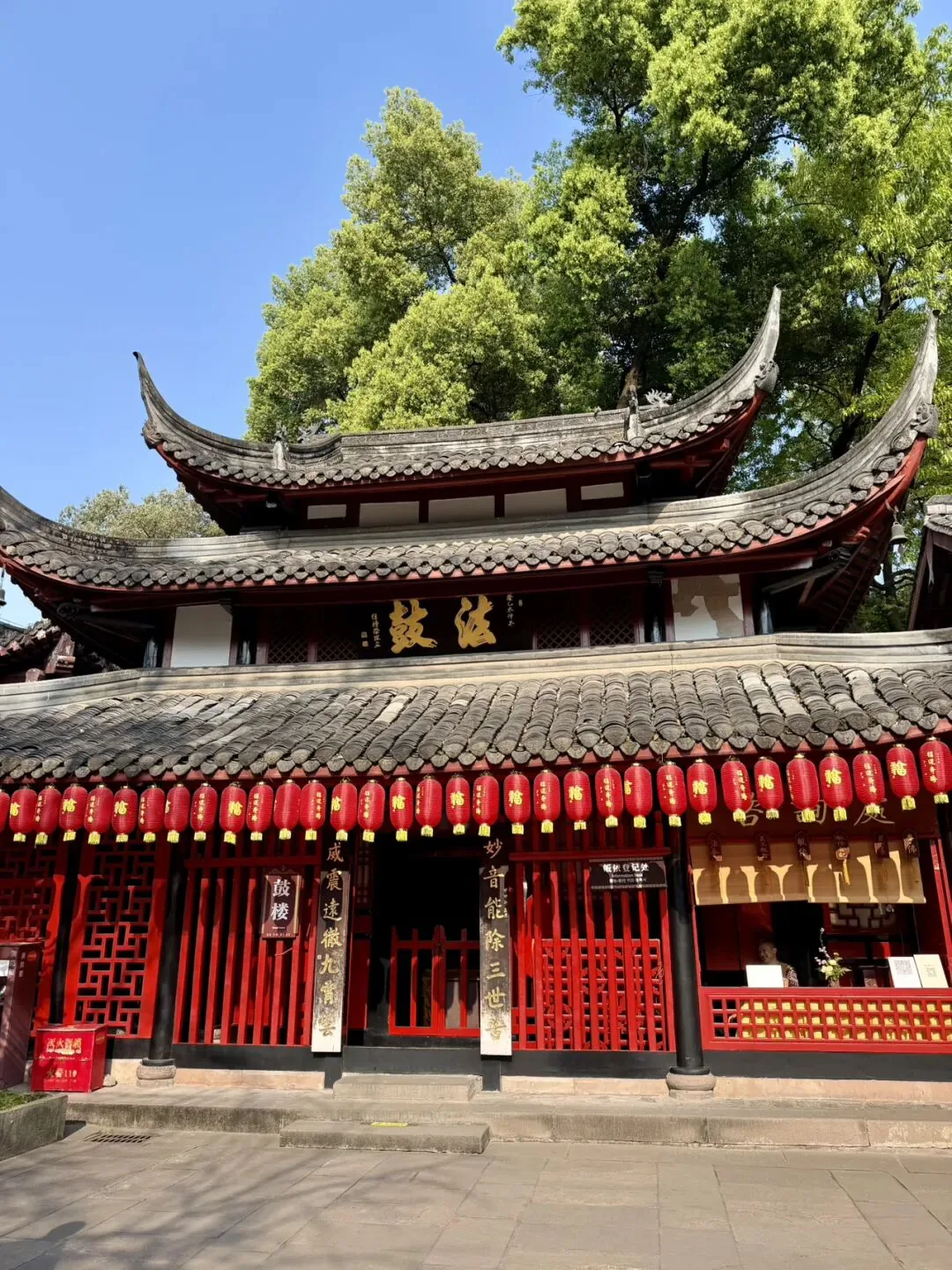Serene red wall and green trees at Wenshu Monastery's surrounding neighborhood