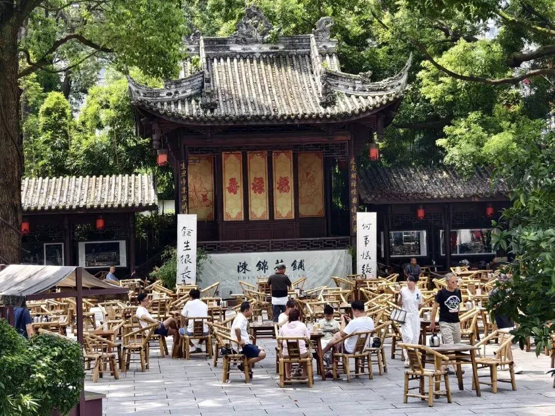 Tea drinkers relaxing under trees at Tiexiang Temple Water Street