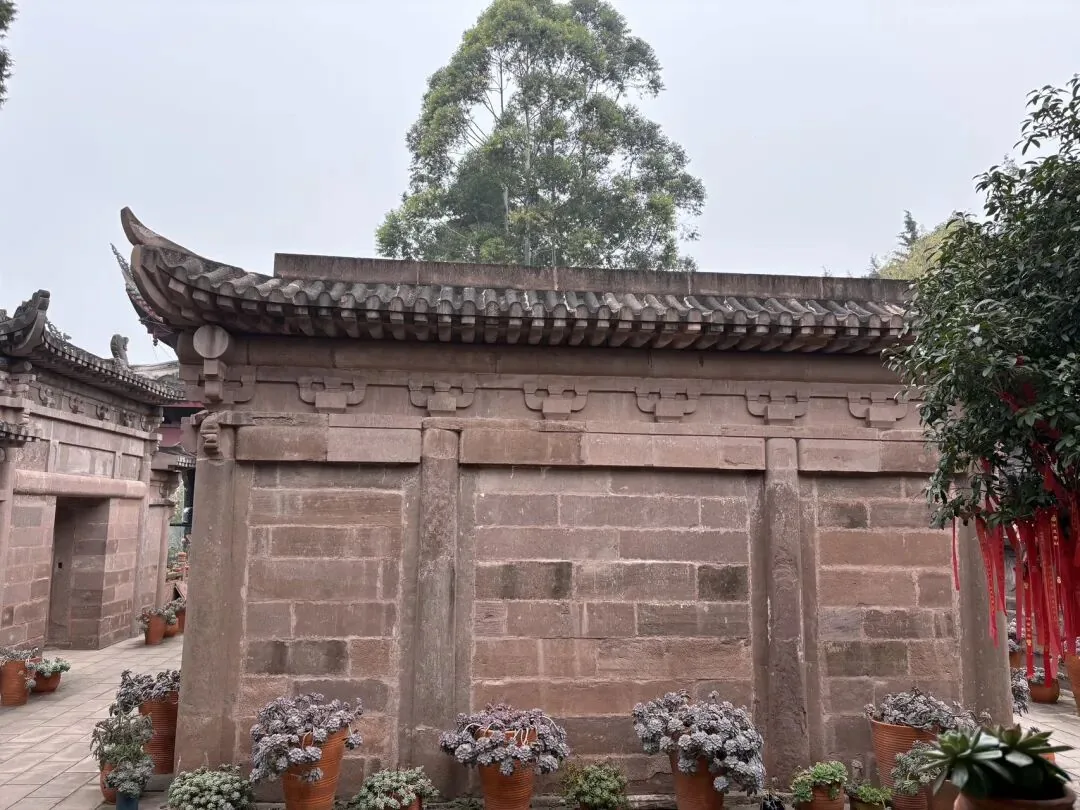 Hand touching warm surface of a 600-year-old stone pagoda