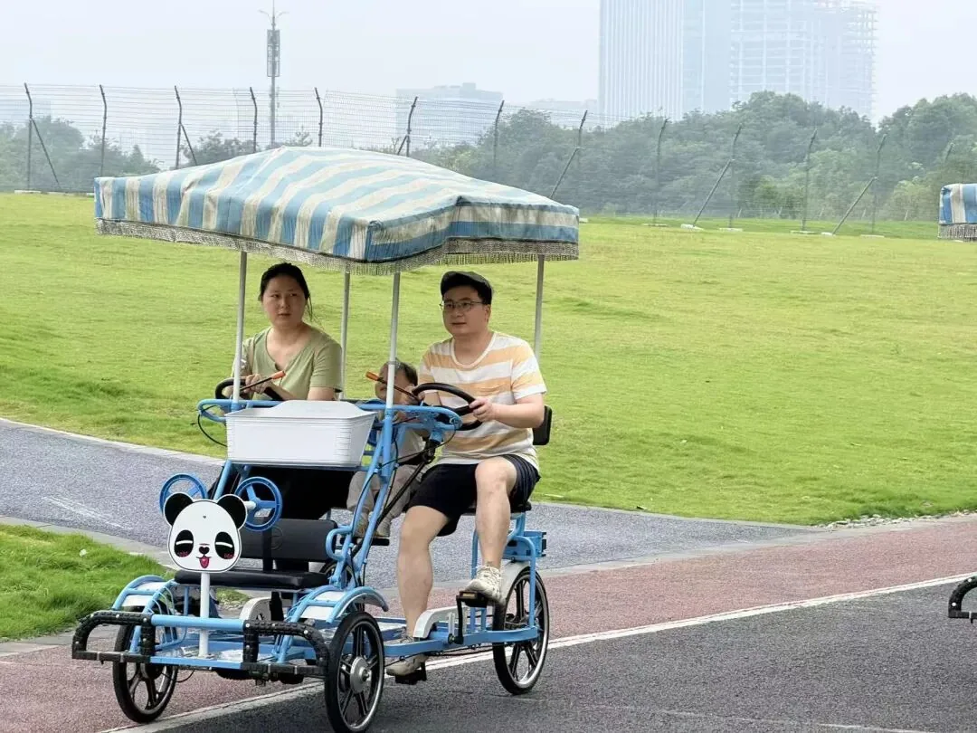 Cyclists riding shared bikes on greenways through Tianfu Park