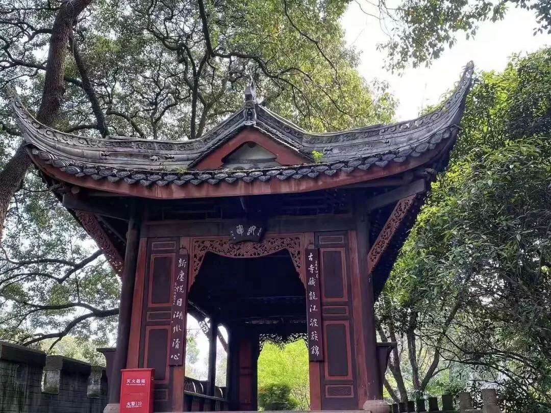 Ancient stone bridge and pavilion over the winding lake at Xinfan East Lake