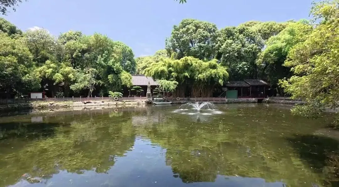 Curving lake with pavilions and lush vegetation at Xinfan East Lake garden
