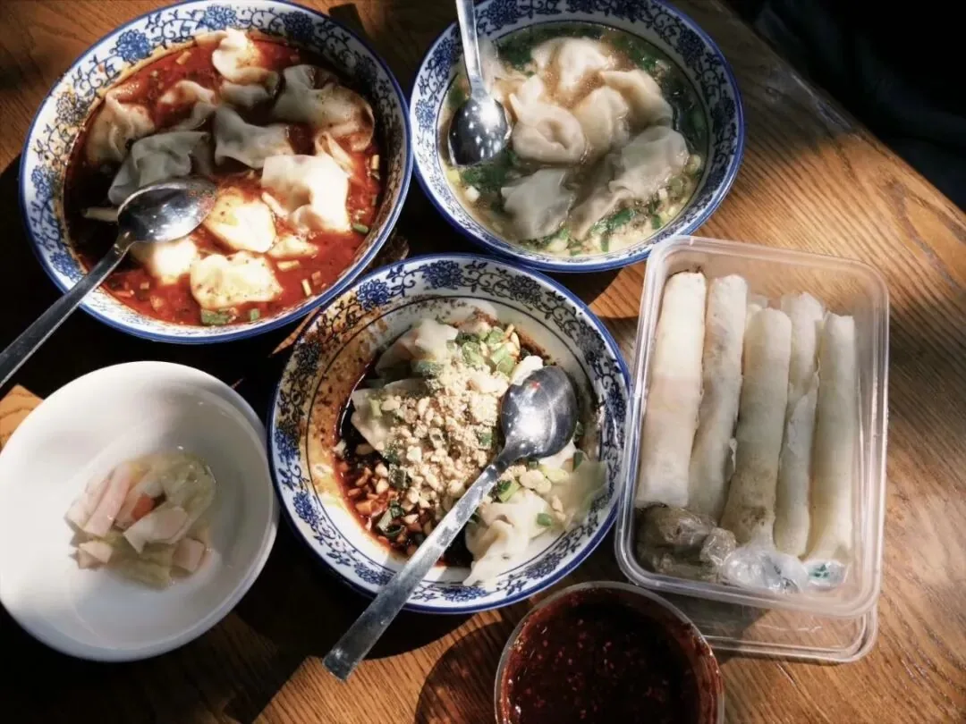 Congcong rolls and local snacks spread on a table in Tangchang