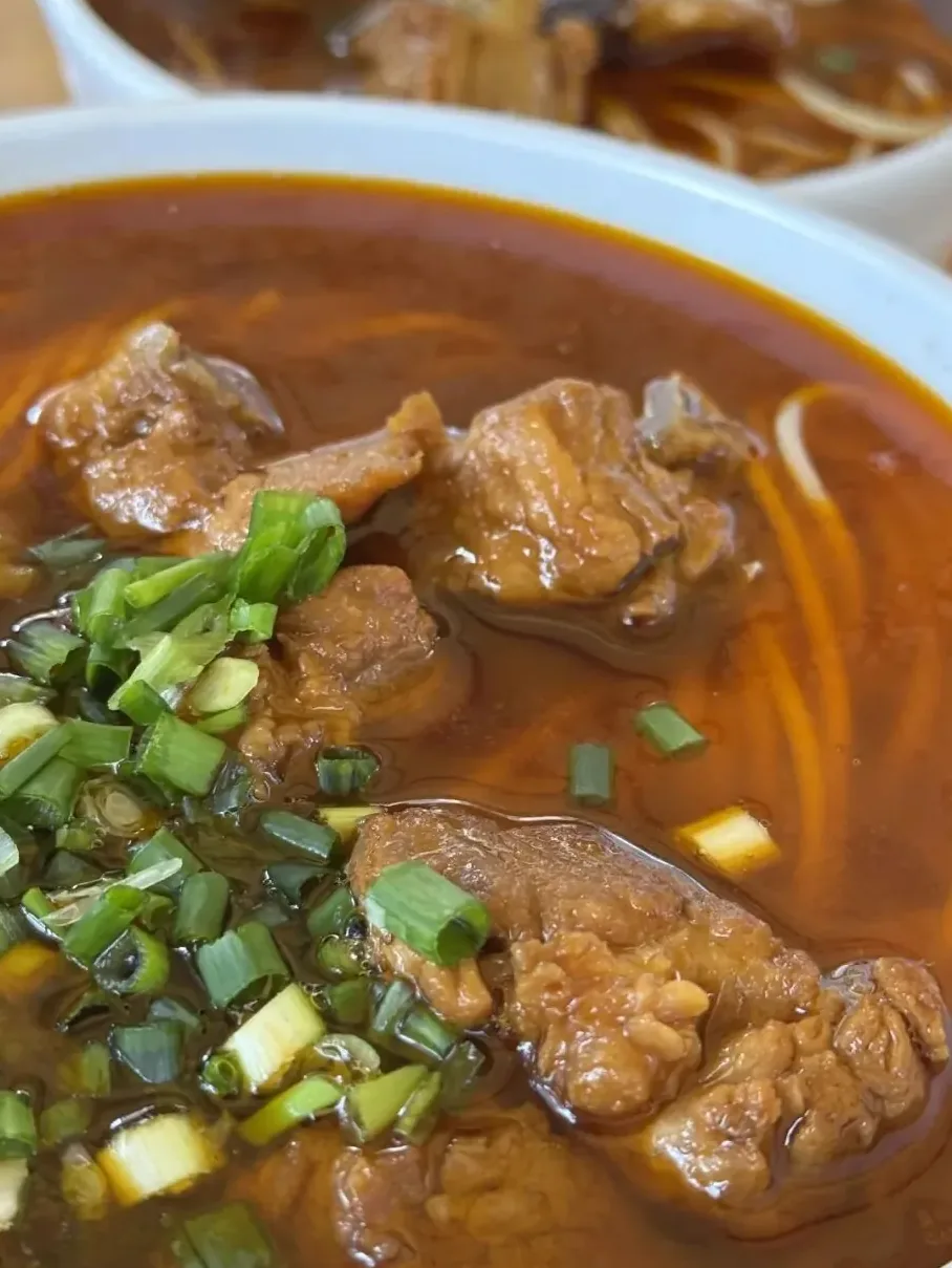 Heavy bowl of pork rib soup noodles with thick chunks of meat