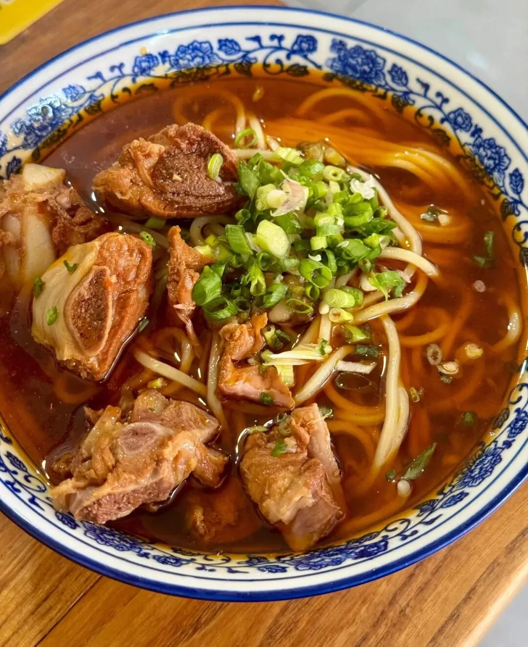 Close-up of chewy gun gun mian noodles in a bowl of pork rib soup