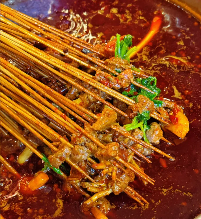 Yulin chuanchuan skewers piled on a table at a Chengdu shop
