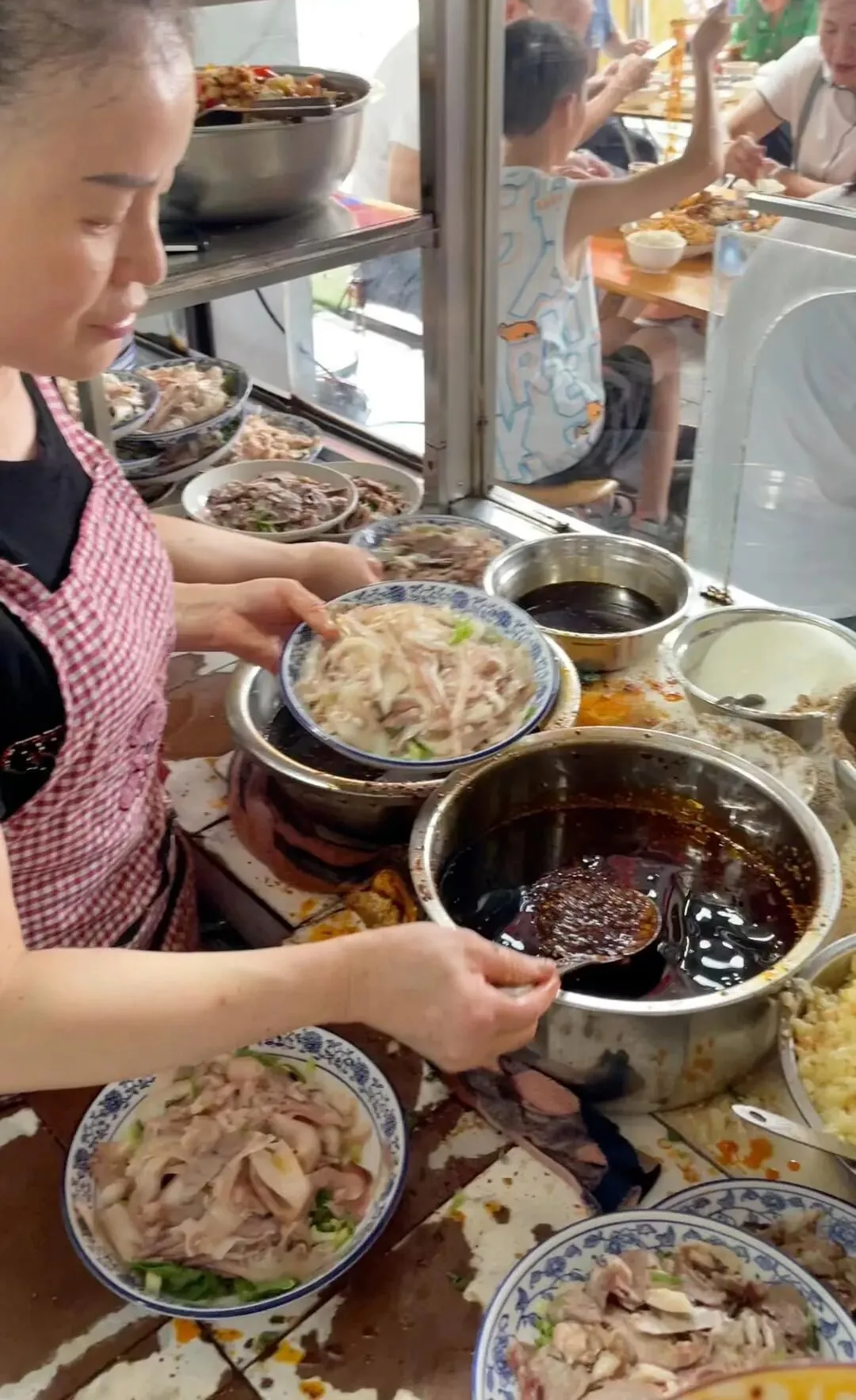 Cold-tossed pig ear slices in red oil at a Yufu Road restaurant in Wenjiang