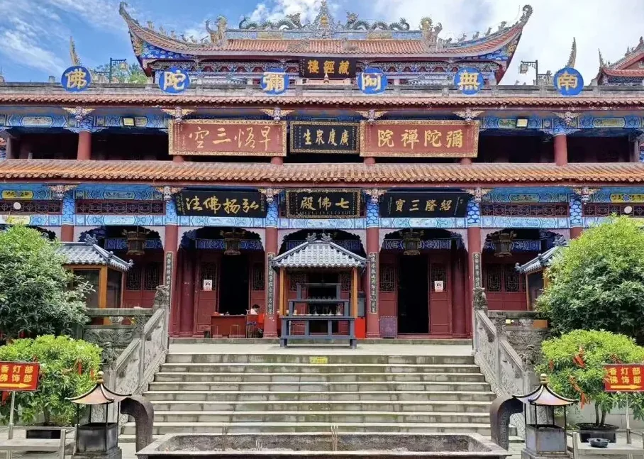 Main hall of Mituo Temple with ancient trees and release pond